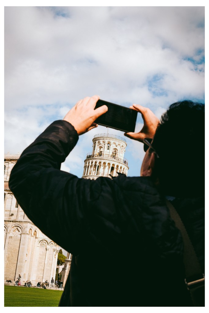 Tourists photographing the leaning tower of Pisa, Italy