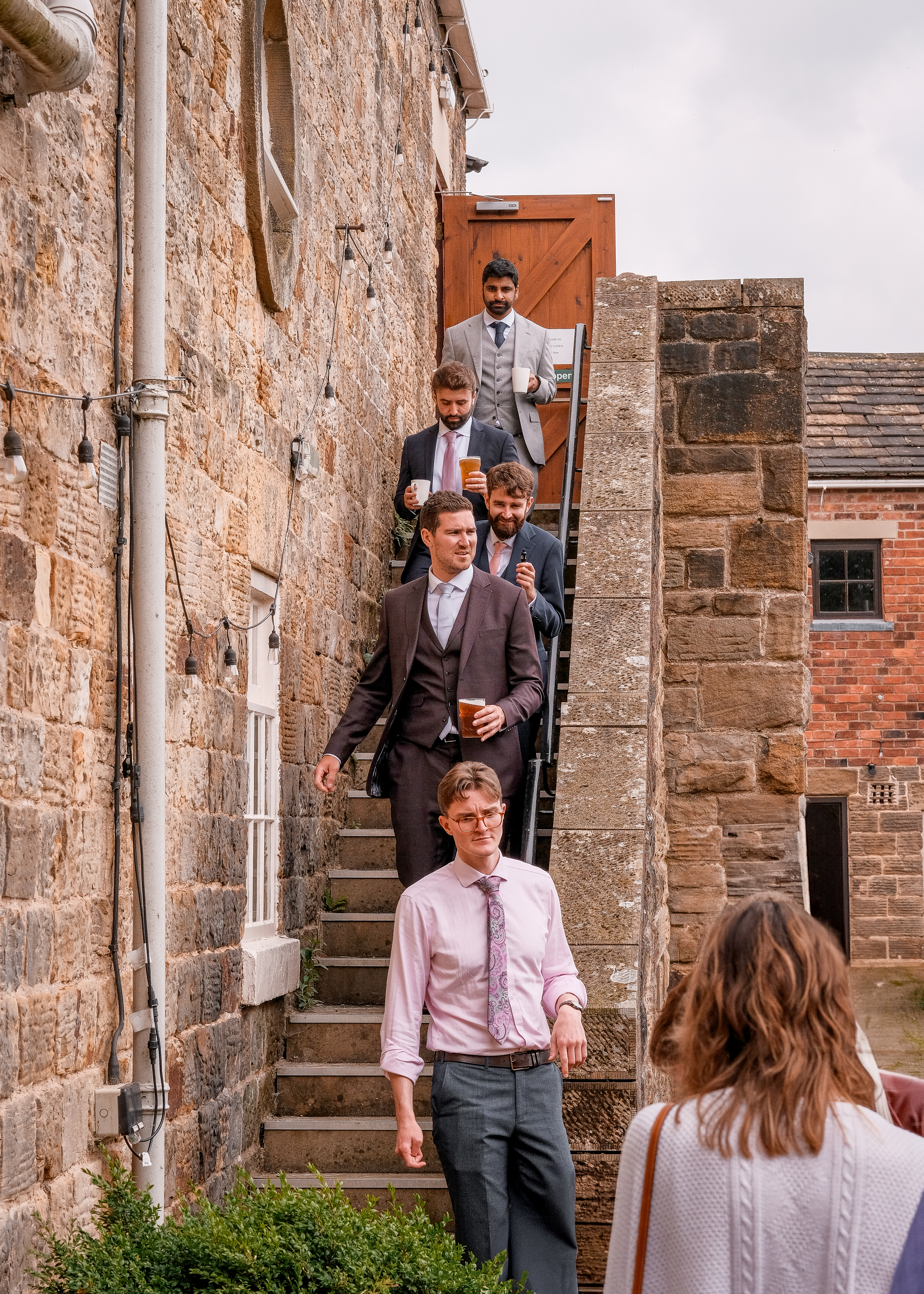 groomsmen group portrait on stairs at a wedding reception